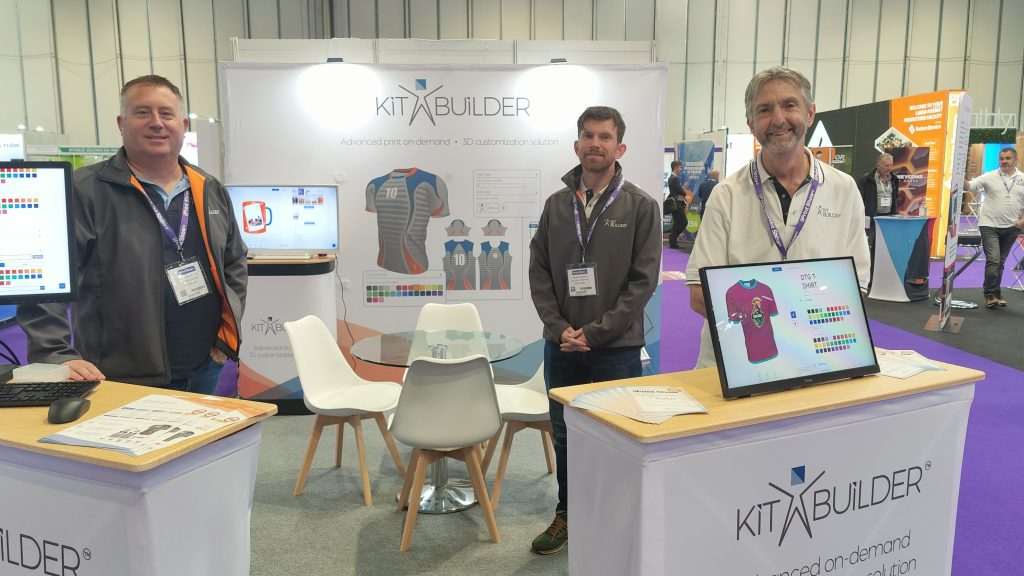 About Us Photo showing the Kit Builder team showing how product customization works at The Print Show at the NEC